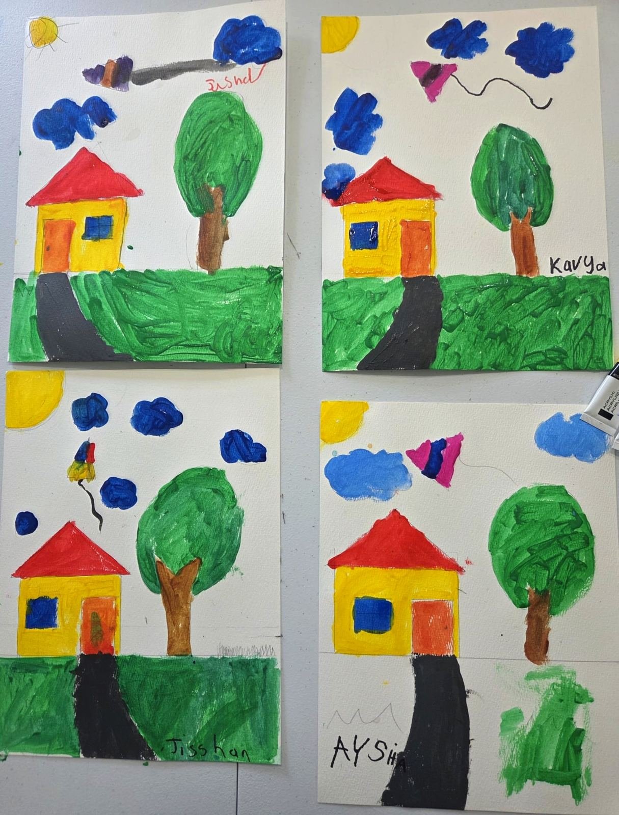 Student paintings of houses and trees from Little Painters class